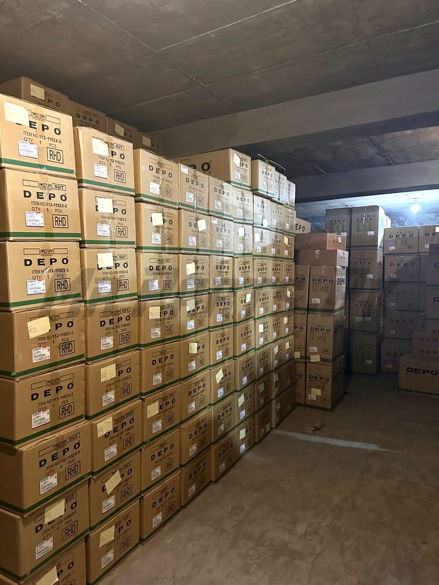 Rows of DEPO auto lamp cartons imported by MrParts.Pk, labelled with item numbers
